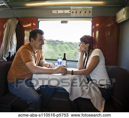 Italy, Venice, Mature couple holding hands while sitting inside of dinning car View Large Photo Image Stock Image - Italy, Venice, Mature couple holding hands while sitting inside of dinning car. Fotosearch