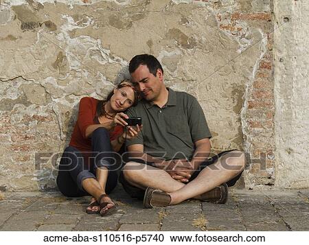 Italy, Venice, Mature couple leaning against wall, watching pictures on digital camera View Large Photo Image Stock Image - Italy, Venice, Mature couple leaning against wall, watching pictures on digital camera. Fotosearch