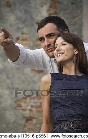 Stock Image - Italy, Venice, Mature couple looking away, man is pointing. Fotosearch