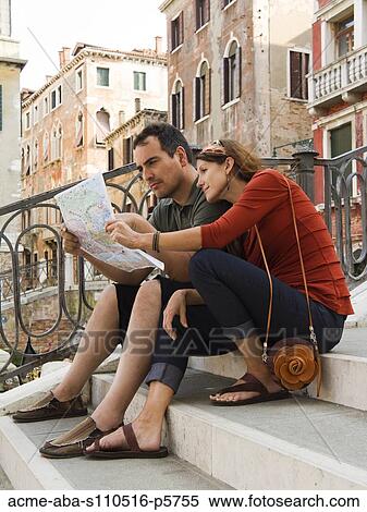 Stock Photography - Italy, Venice, Mature couple on vacations studying city map. Fotosearch