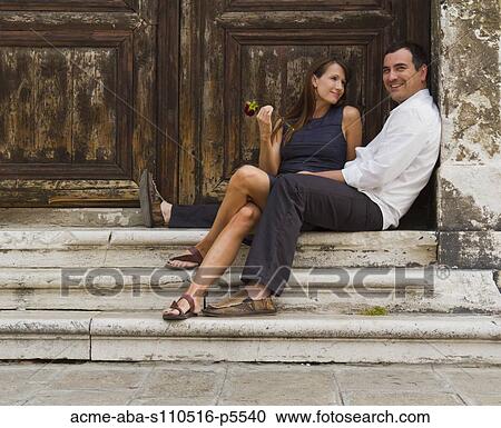 Italy, Venice, Mature couple sitting together at steps, woman holding red rose View Large Photo Image Stock Image - Italy, Venice, Mature couple sitting together at steps, woman holding red rose. Fotosearch