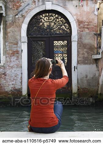 Italy, Venice, Mature woman posing by historic canal View Large Photo Image Stock Photo - Italy, Venice, Mature woman posing by historic canal. Fotosearch