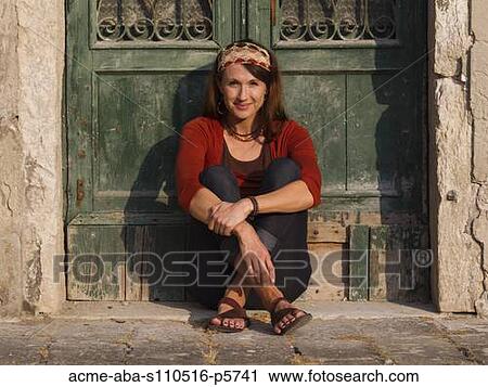 Italy, Venice, Mature woman sitting by old green door View Large Photo Image Stock Image - Italy, Venice, Mature woman sitting by old green door. Fotosearch
