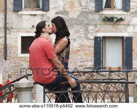 Italy, Venice nice, Young couple kissing on small bridge over canal View Large Photo Image Stock Image - Italy, Venice nice, Young couple kissing on small bridge over canal. Fotosearch