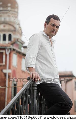 Italy, Venice, Portrait of man standing on footbridge View Large Photo Image Stock Photo - Italy, Venice, Portrait of man standing on footbridge. Fotosearch