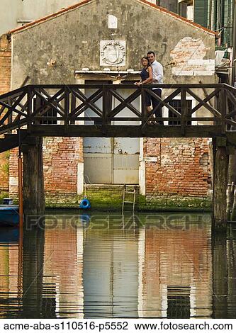 Italy, Venice, Portrait of mature couple standing on small bridge View Large Photo Image Stock Image - Italy, Venice, Portrait of mature couple standing on small bridge. Fotosearch