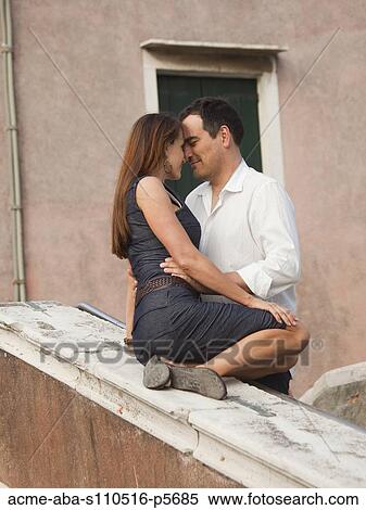 Stock Photography - Italy, Venice, Romantic couple flirting outdoors. Fotosearch