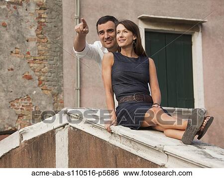 Italy, Venice, Romantic couple sitting on rooftop View Large Photo Image Stock Photograph - Italy, Venice, Romantic couple sitting on rooftop. Fotosearch