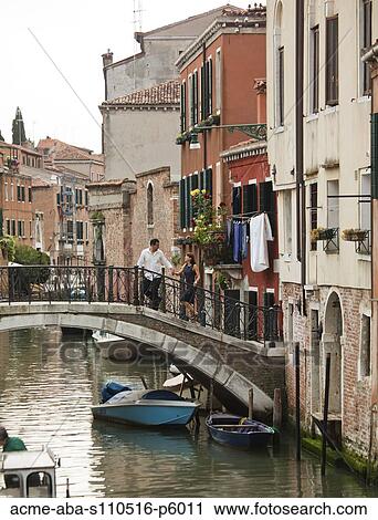 Italy, Venice, Romantic couple walking on footbridge over canal View Large Photo Image Stock Image - Italy, Venice, Romantic couple walking on footbridge over canal. Fotosearch