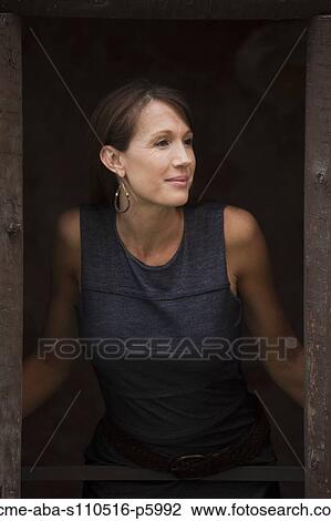 Italy, Venice, Woman looking through old wooden window View Large Photo Image Stock Image - Italy, Venice, Woman looking through old wooden window. Fotosearch