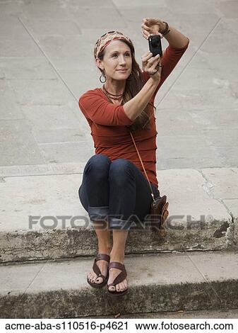 Italy, Venice, Woman using digital camera on steps View Large Photo Image Stock Image - Italy, Venice, Woman using digital camera on steps. Fotosearch