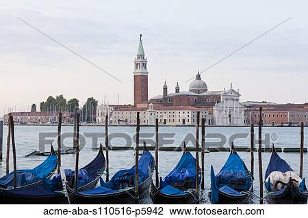 Italy, Venice, Young couple embracing by lagoon, gondolas and San Giorgio Maggiore church in background View Large Photo Image Stock Image - Italy, Venice, Young couple embracing by lagoon, gondolas and San Giorgio Maggiore church in background. Fotosearch