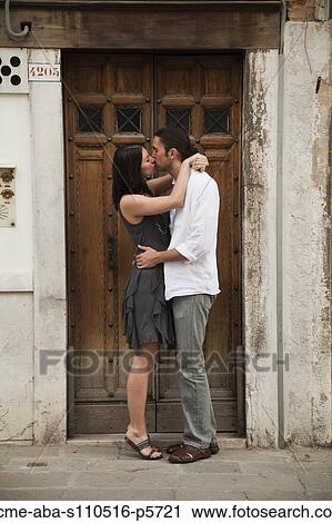 Italy, Venice, Young couple kissing in front of old door View Large Photo Image Stock Image - Italy, Venice, Young couple kissing in front of old door. Fotosearch