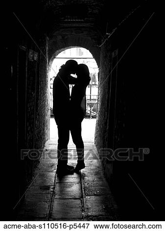 Stock Photo - Italy, Venice, Young couple kissing in archway. Fotosearch