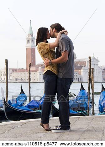 Italy, Venice, Young couple kissing in front of San Giorgio Maggiore Church View Large Photo Image Stock Photo - Italy, Venice, Young couple kissing in front of San Giorgio Maggiore Church. Fotosearch