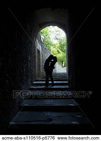Stock Photograph - Italy, Venice, Young couple kissing in archway. Fotosearch