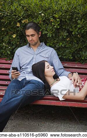 Italy, Venice, Young couple relaxing on bench View Large Photo Image Stock Image - Italy, Venice, Young couple relaxing on bench. Fotosearch
