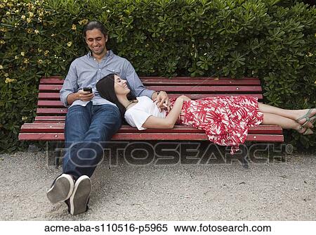 Italy, Venice, Young couple relaxing on bench View Large Photo Image Stock Photography - Italy, Venice, Young couple relaxing on bench. Fotosearch
