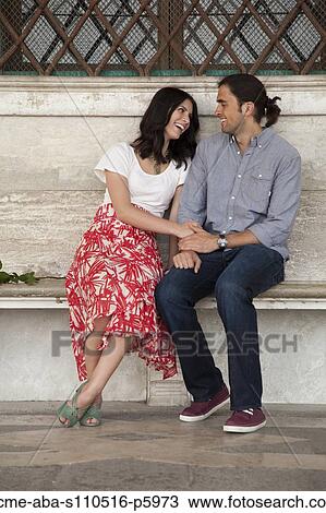 Italy, Venice, Young couple sitting on bench View Large Photo Image Stock Image - Italy, Venice, Young couple sitting on bench. Fotosearch