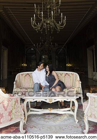 Italy, Venice, Young couple sitting together in luxury room View Large Photo Image Stock Photo - Italy, Venice, Young couple sitting together in luxury room. Fotosearch