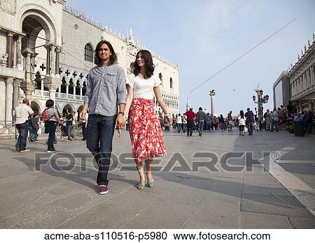 Italy, Venice, Young couple walking on St. Mark's Square View Large Photo Image Stock Image - Italy, Venice, Young couple walking on St. Mark's Square. Fotosearch