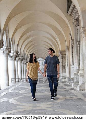 Italy, Venice, Young couple walking on St. Mark's Square View Large Photo Image Stock Photo - Italy, Venice, Young couple walking on St. Mark's Square. Fotosearch