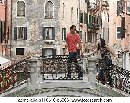 Italy, Venice, Young couple walking on footbridge View Large Photo Image Stock Photograph - Italy, Venice, Young couple walking on footbridge. Fotosearch