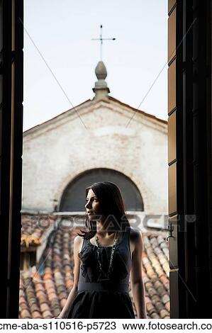 Italy, Venice, Young woman standing in balcony door, contemplating view View Large Photo Image Stock Image - Italy, Venice, Young woman standing in balcony door, contemplating view. Fotosearch