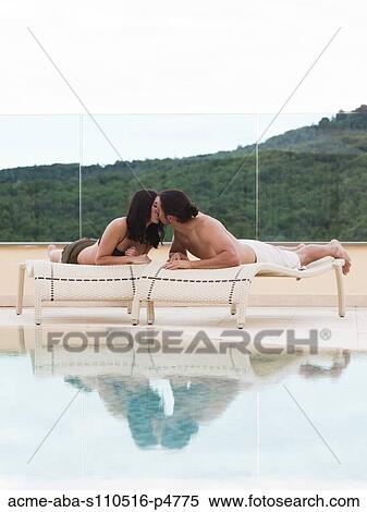 Italy, Young couple kissing by swimming pool View Large Photo Image Stock Photography - Italy, Young couple kissing by swimming pool. Fotosearch