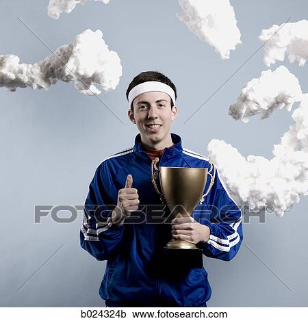 Stock Image - jogger holding a trophy. Fotosearch