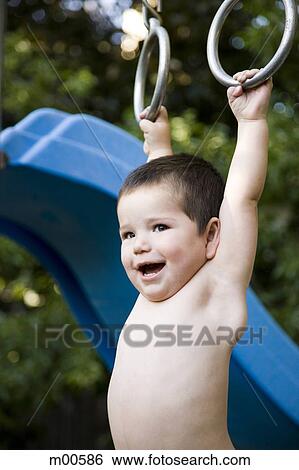 little boy hanging from a jungle gym View Large Photo Image Stock Photograph - little boy hanging from a jungle gym. Fotosearch