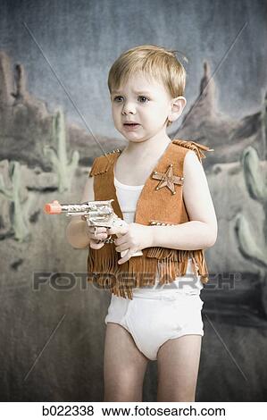 Stock Photo - little boy pretending to be cowboy. Fotosearch