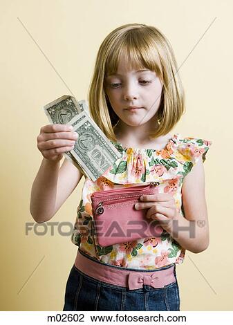Stock Image - little girl putting money in her pink wallet. Fotosearch