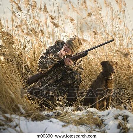 Stock Image - man and his dog duck hunting. Fotosearch