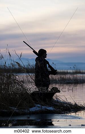 Stock Image - man and his dog duck hunting. Fotosearch