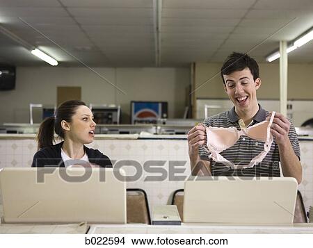 Picture - man and woman at a laundromat. Fotosearch