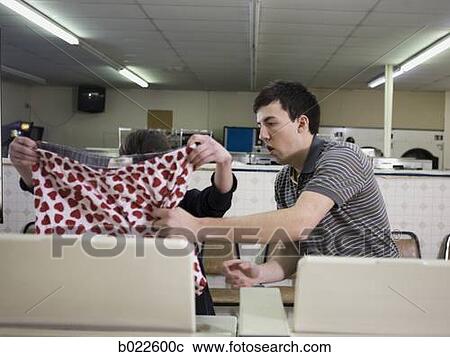 man and woman at a laundromat View Large Photo Image Stock Image - man and woman at a laundromat. Fotosearch
