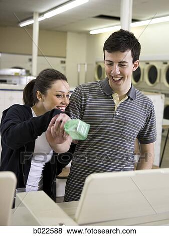 man and woman at a laundromat View Large Photo Image Stock Photo - man and woman at a laundromat. Fotosearch