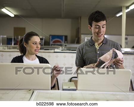 man and woman at a laundromat View Large Photo Image Stock Photo - man and woman at a laundromat. Fotosearch