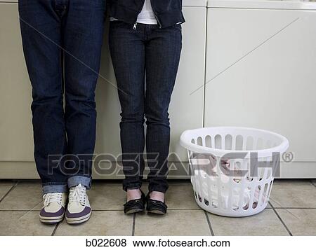 Stock Photo - man and woman at a laundromat. Fotosearch