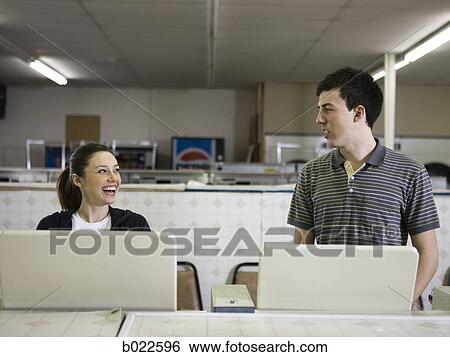 man and woman at a laundromat View Large Photo Image Stock Photograph - man and woman at a laundromat. Fotosearch