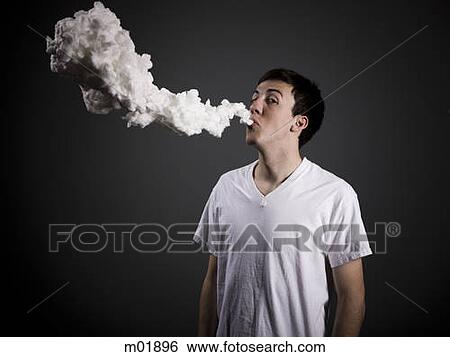 Stock Photograph - man blowing smoke. Fotosearch