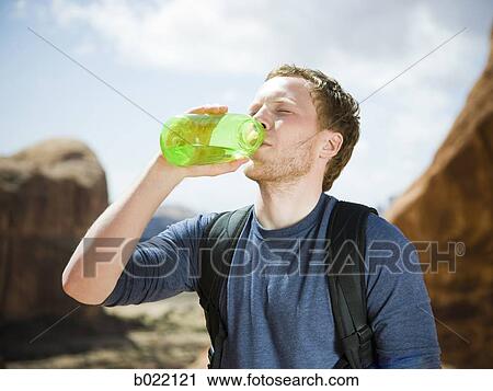 man drinking water in the desert View Large Photo Image Stock Image - man drinking water in the desert. Fotosearch