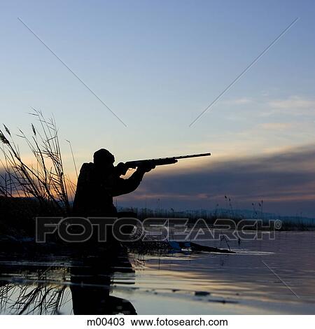 Stock Image - man duck hunting. Fotosearch
