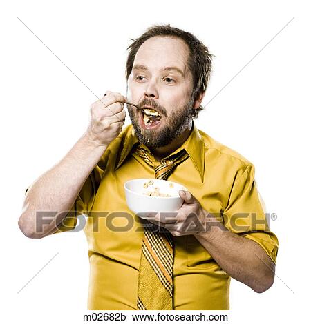 Stock Image - man eating a bowl of cereal. Fotosearch