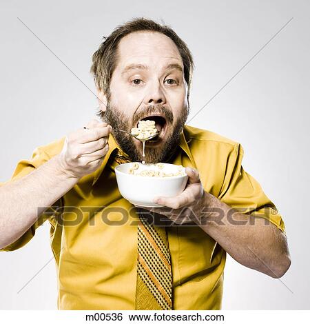 Stock Photograph - man eating cereal. Fotosearch
