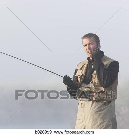 man fishing in a river on his cell phone View Large Photo Image Stock Photo - man fishing in a river on his cell phone. Fotosearch