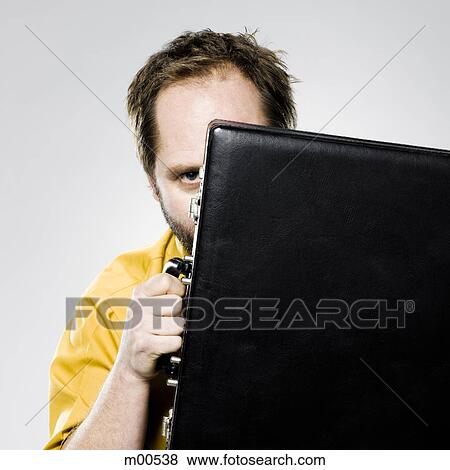 man hiding behind his briefcase View Large Photo Image Stock Photo - man hiding behind his briefcase. Fotosearch