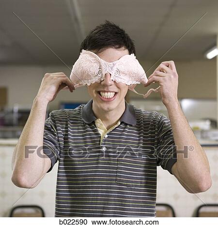 man holding a bra over his eyes View Large Photo Image Stock Image - man holding a bra over his eyes. Fotosearch