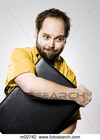 Stock Image - man holding a briefcase. Fotosearch